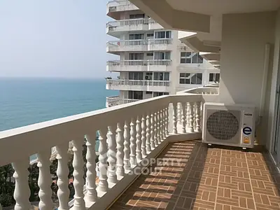 Spacious balcony with ocean view in modern high-rise apartment