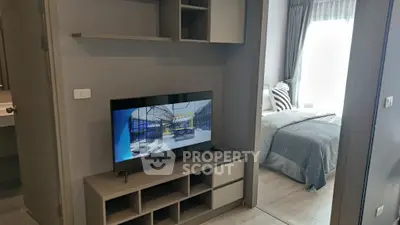 Modern apartment interior with TV and cozy bedroom, perfect for urban living.