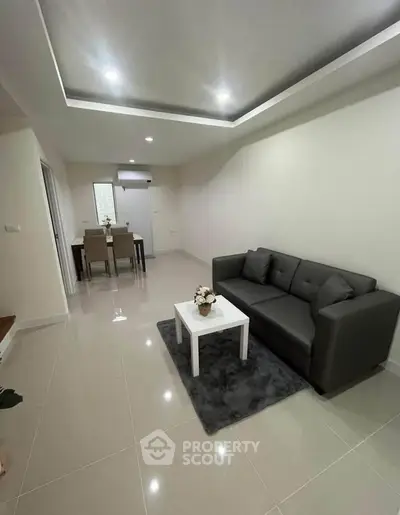 Modern living room with sleek sofa and elegant dining area