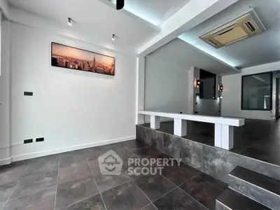 Modern interior with sleek design, featuring tiled flooring and stylish lighting, perfect for contemporary living.