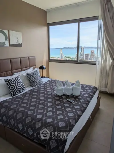 Luxurious bedroom with stunning ocean view in high-rise apartment