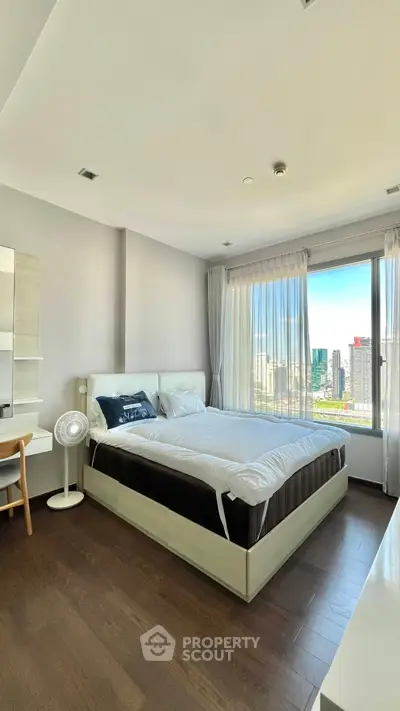 Spacious bedroom with city view and modern furnishings