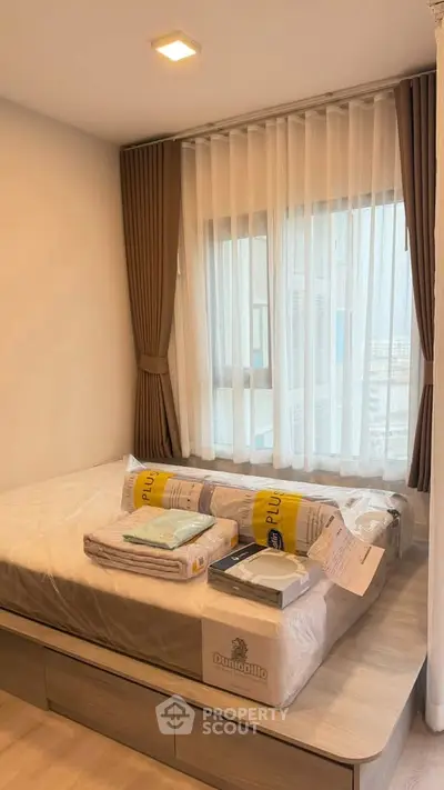 Cozy bedroom with natural light and modern furnishings, perfect for relaxation and comfort.