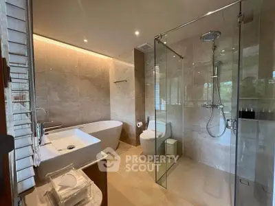 Luxurious modern bathroom with freestanding tub and glass shower enclosure