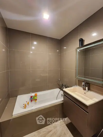 Modern bathroom with sleek design and bathtub in contemporary home.