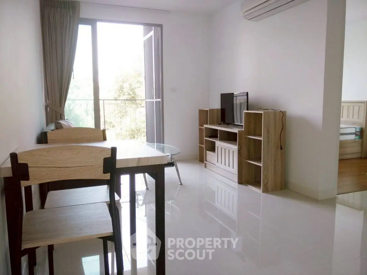 Modern living room with sleek furniture and large window for natural light.