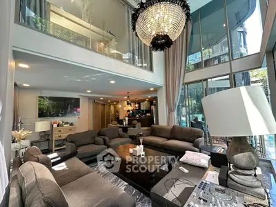 Luxurious modern living room with high ceilings and elegant chandelier in a stylish apartment
