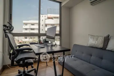 Modern study room with large window and city view, featuring ergonomic chair and sleek desk setup.