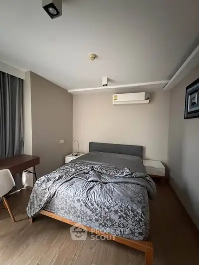 Modern bedroom with stylish decor and air conditioning in a cozy apartment.