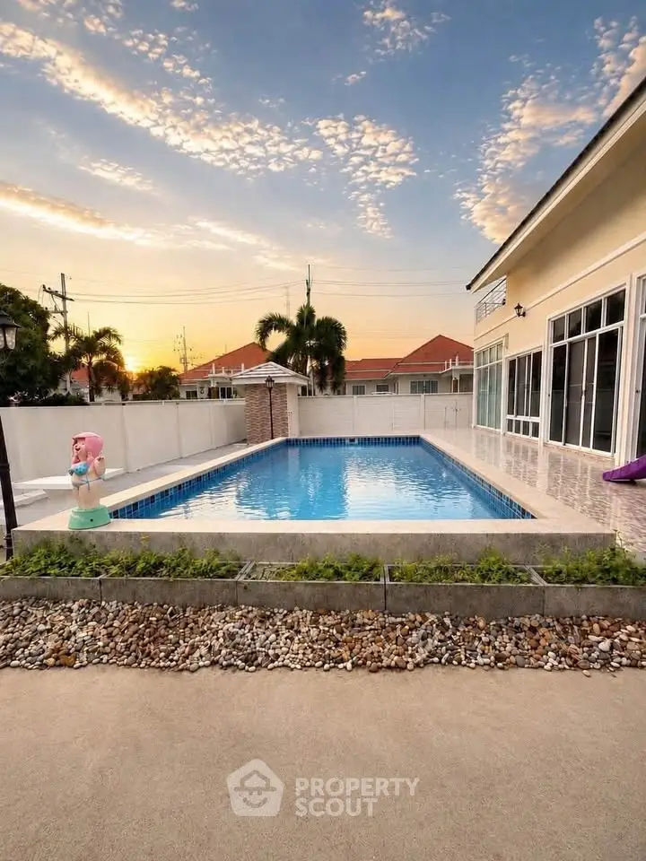 Stunning backyard pool with sunset view in modern residential property.