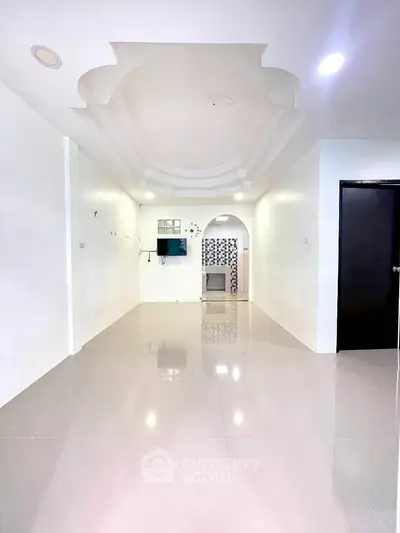Spacious living room with modern ceiling design and glossy tiled flooring