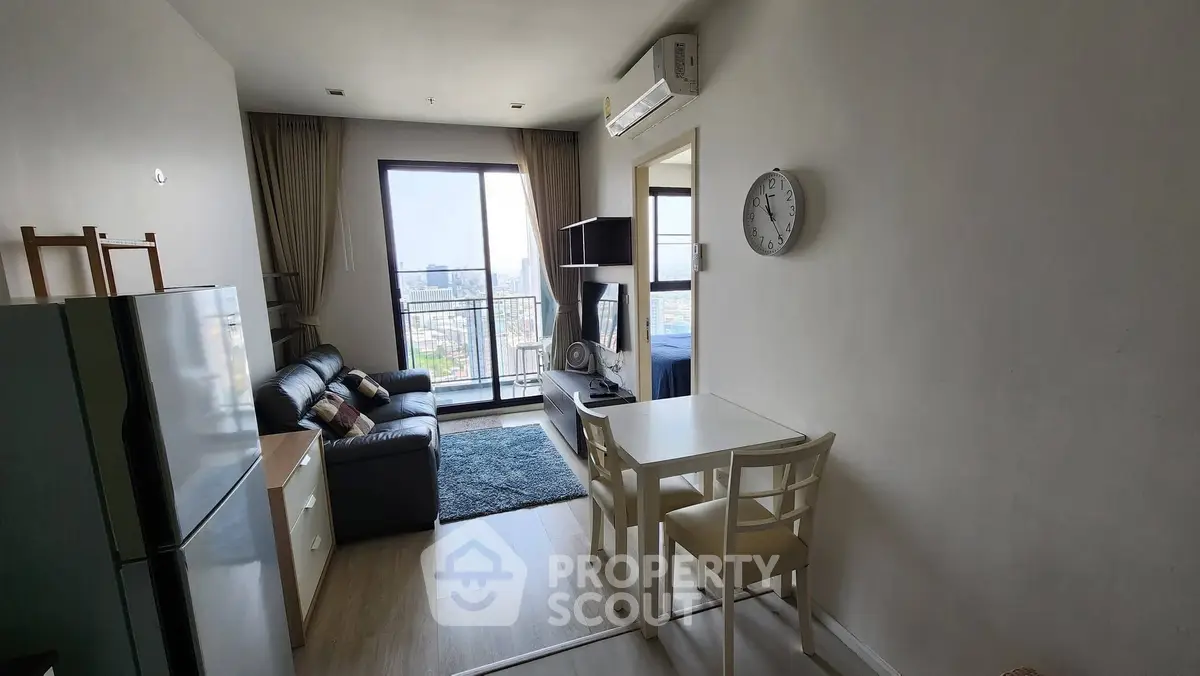 Modern living room with city view, sleek furniture, and open layout in urban apartment.
