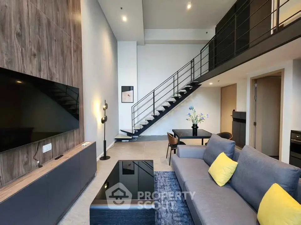 Modern duplex living room with stylish decor and open staircase