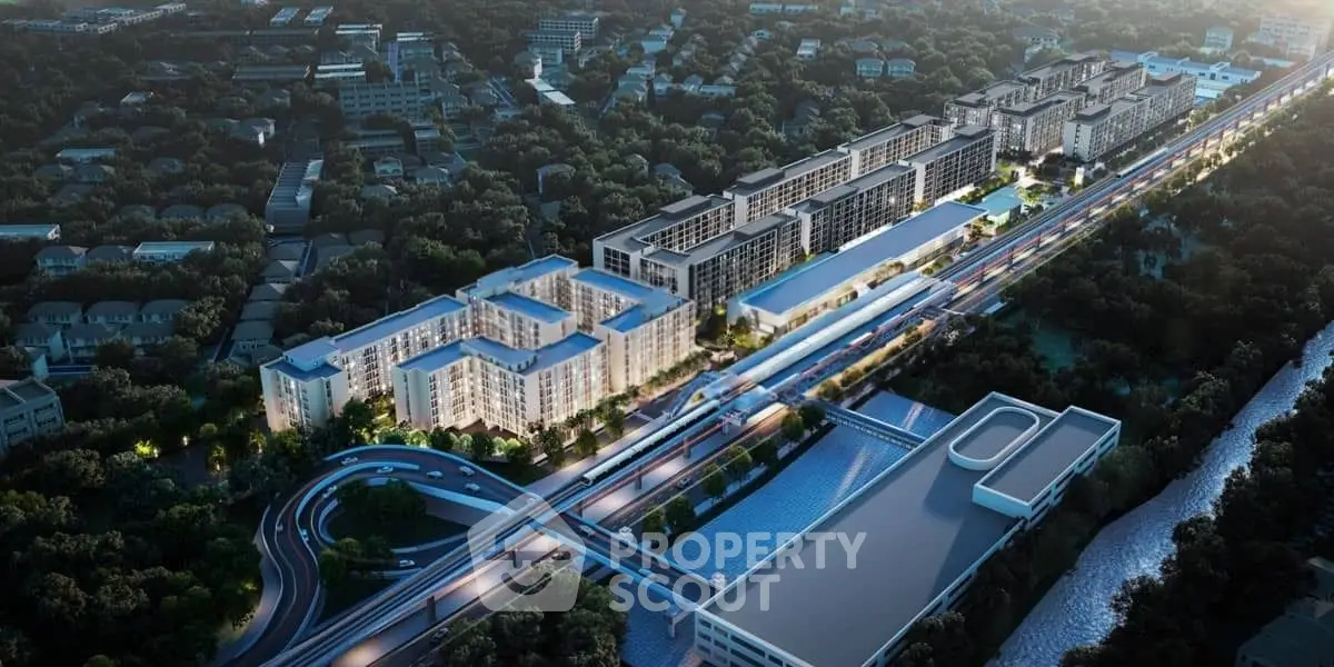 Aerial view of modern residential complex with lush surroundings and convenient road access.