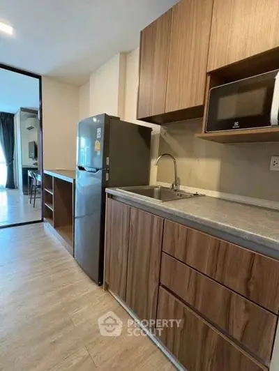 Modern kitchen with sleek wooden cabinets and stainless steel appliances