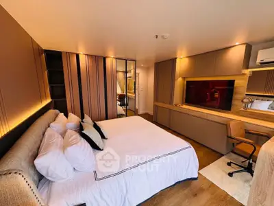 Luxurious bedroom with modern decor, featuring a large bed, built-in storage, and ambient lighting.
