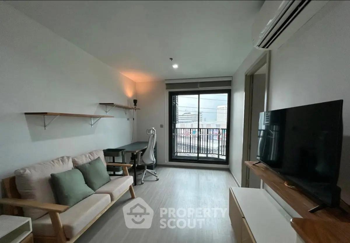 Modern living room with sleek furniture and city view balcony, perfect for urban living.