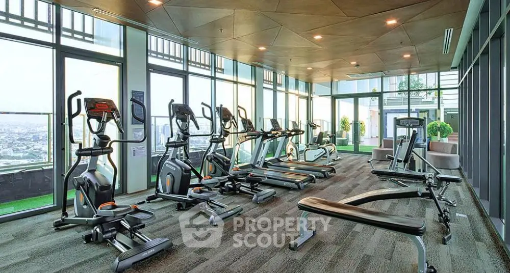 Spacious modern gym with panoramic city views and state-of-the-art equipment.