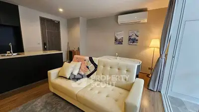 Modern living room with stylish sofa and air conditioning, featuring cozy lighting and elegant decor.