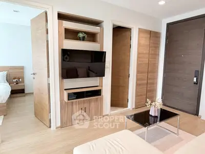 Modern living room with wooden accents and sleek TV setup in a stylish apartment.