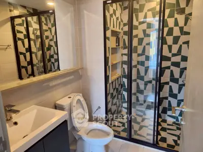 Modern bathroom with geometric tile shower and sleek fixtures