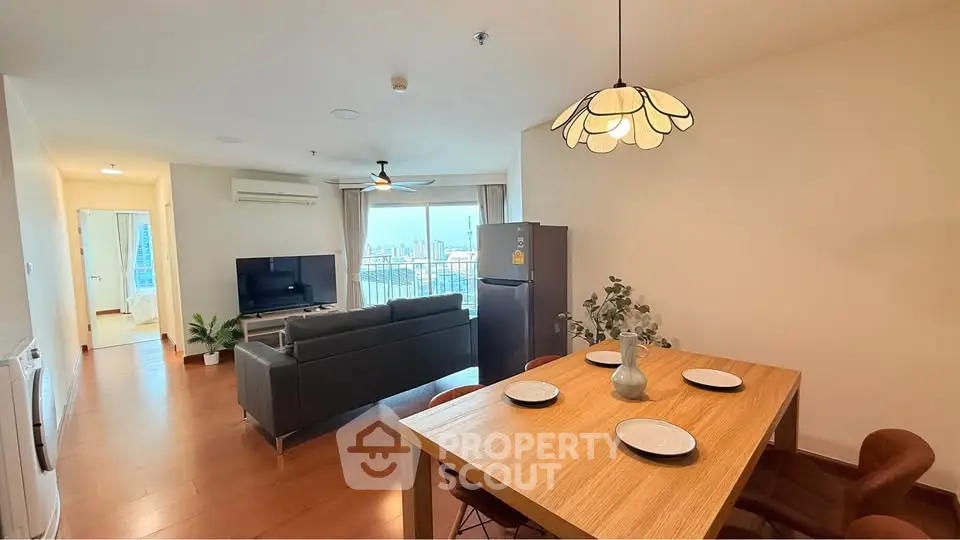 Spacious modern living room with city view, open layout dining area, and stylish lighting.