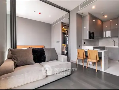 Modern open-plan living room with sleek kitchen and cozy seating area