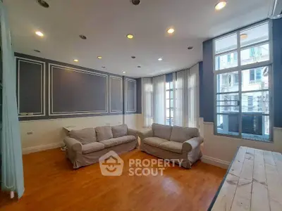 Spacious living room with elegant decor and large windows for natural light.