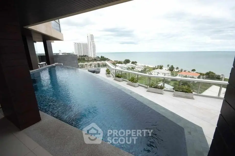 Luxurious rooftop infinity pool with stunning ocean view in a high-rise building.