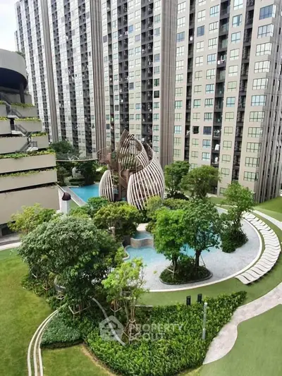 Luxurious high-rise building with modern architecture and lush landscaped garden featuring a unique pool area.