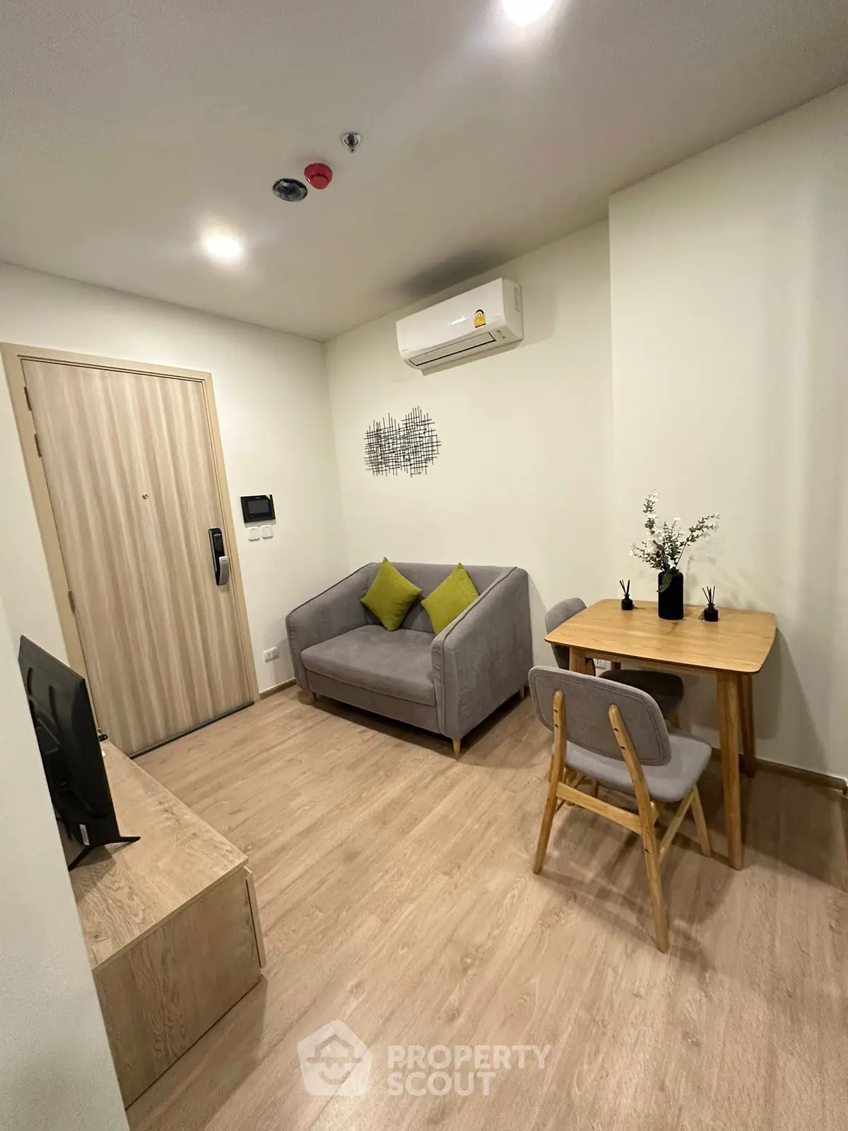 Cozy living room with modern furniture and air conditioning in a stylish apartment.