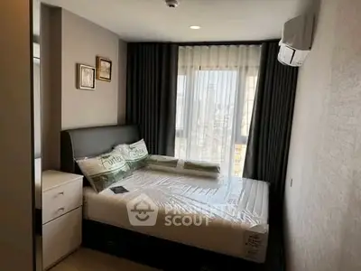 Modern bedroom with large window and stylish decor in a high-rise apartment.