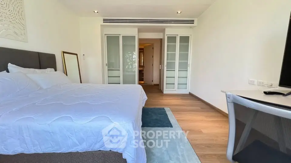 Spacious modern bedroom with elegant decor and natural light