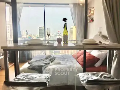 Stunning city view from modern bedroom with elegant dining setup and cozy ambiance.