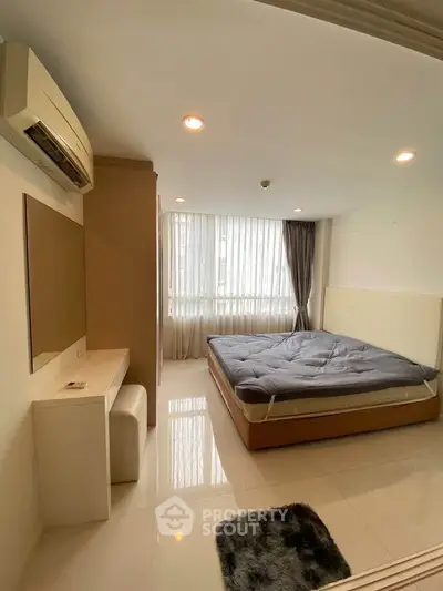 Modern bedroom with large window, air conditioning, and sleek furniture in a bright apartment.