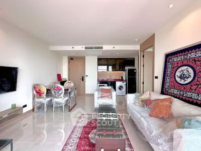 Spacious living room with modern decor and open kitchen layout in a stylish apartment.