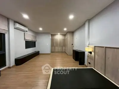 Spacious modern living room with wooden flooring and ambient lighting