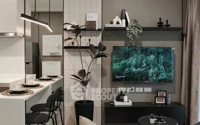 Modern living room with sleek decor and wall-mounted TV, featuring a stylish open kitchen layout.