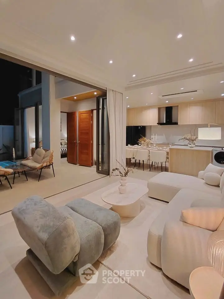 Luxurious open-plan living room with modern kitchen and elegant furnishings