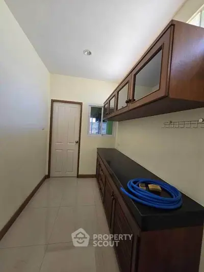 Spacious storage room with wooden cabinets and sleek countertop
