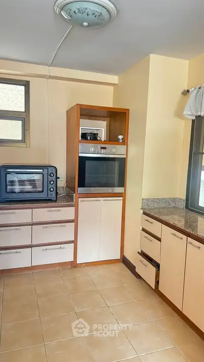 Spacious kitchen with modern appliances and ample storage in a bright, airy setting.