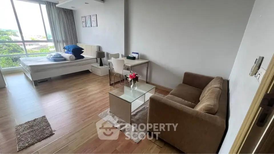 Modern studio apartment with cozy living area and natural light