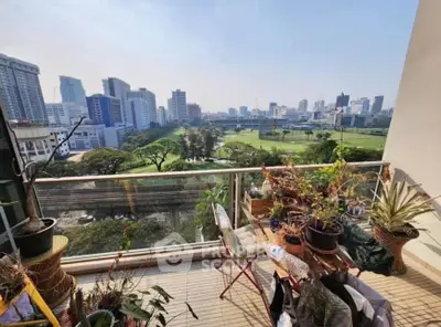 Stunning balcony view overlooking city skyline and lush greenery, perfect for urban living enthusiasts.
