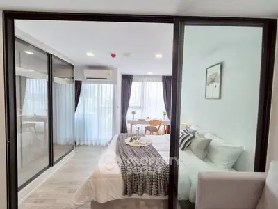 Modern bedroom with glass sliding doors and stylish decor