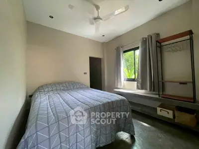 Cozy bedroom with modern decor and natural light, featuring a comfortable bed and minimalist design.