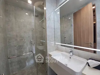 Modern bathroom with glass shower and sleek sink design