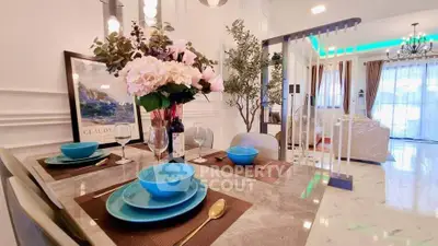 Luxurious open-plan living and dining area with elegant decor and modern furnishings.