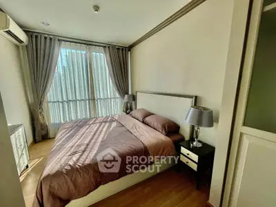 Cozy bedroom with natural light, featuring a comfortable bed and elegant decor, perfect for relaxation.