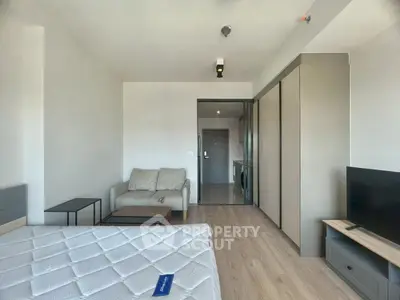 Modern studio apartment with sleek furnishings and natural light