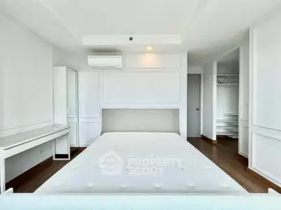 Spacious bedroom with modern design and ample natural light, featuring built-in storage and sleek air conditioning unit.